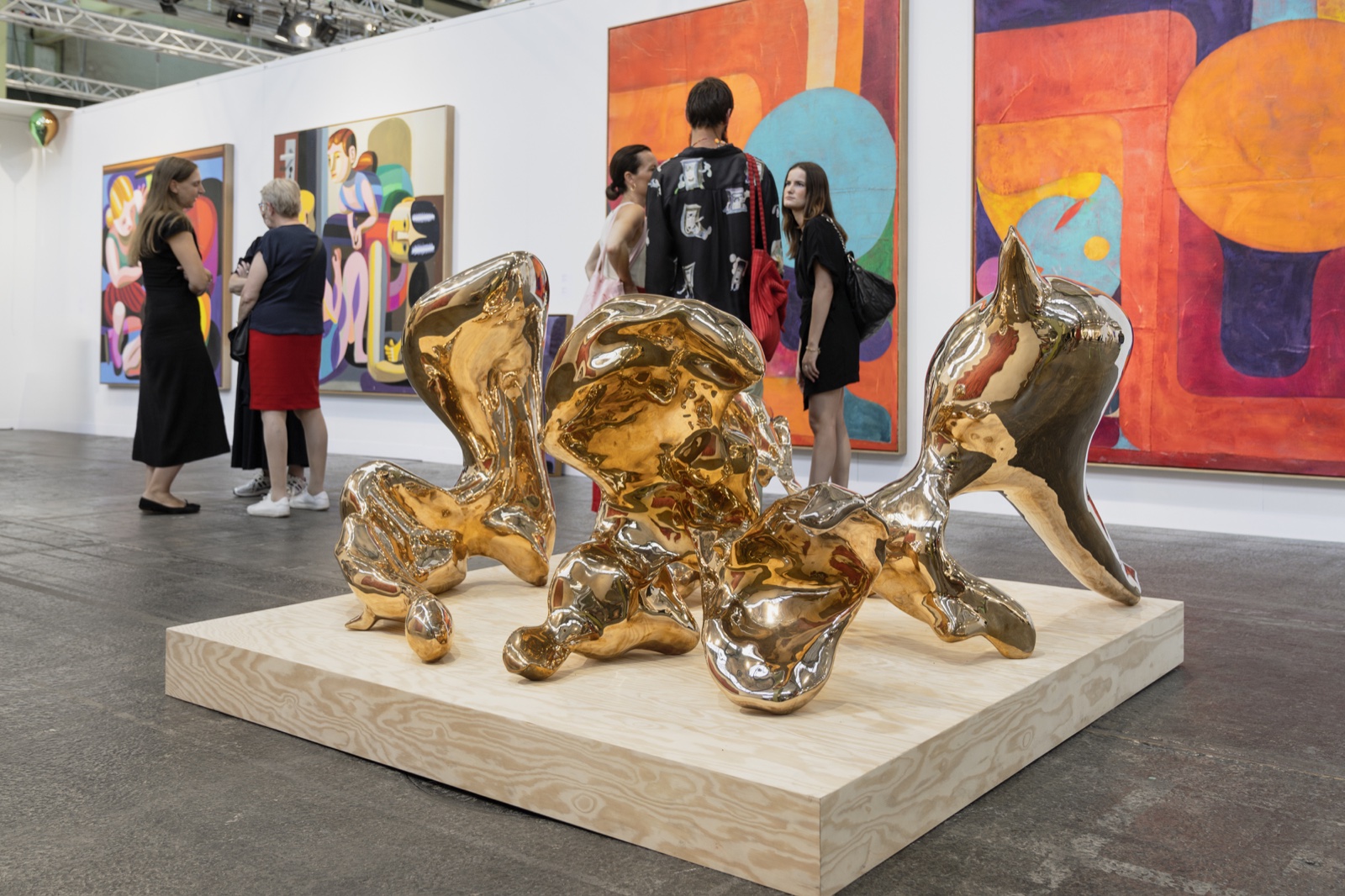 Visitors viewing contemporary sculpture and painting at Enter Art Fair