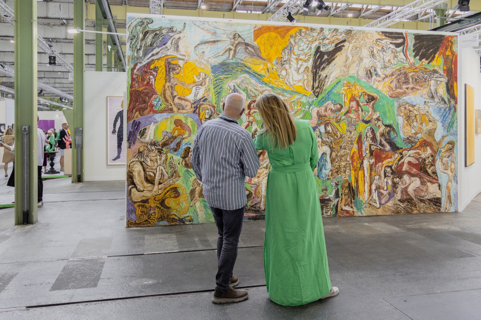 Visitors in front of a large painting at Enter Art Fair